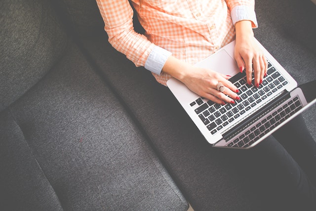 a person on a couch using a laptop